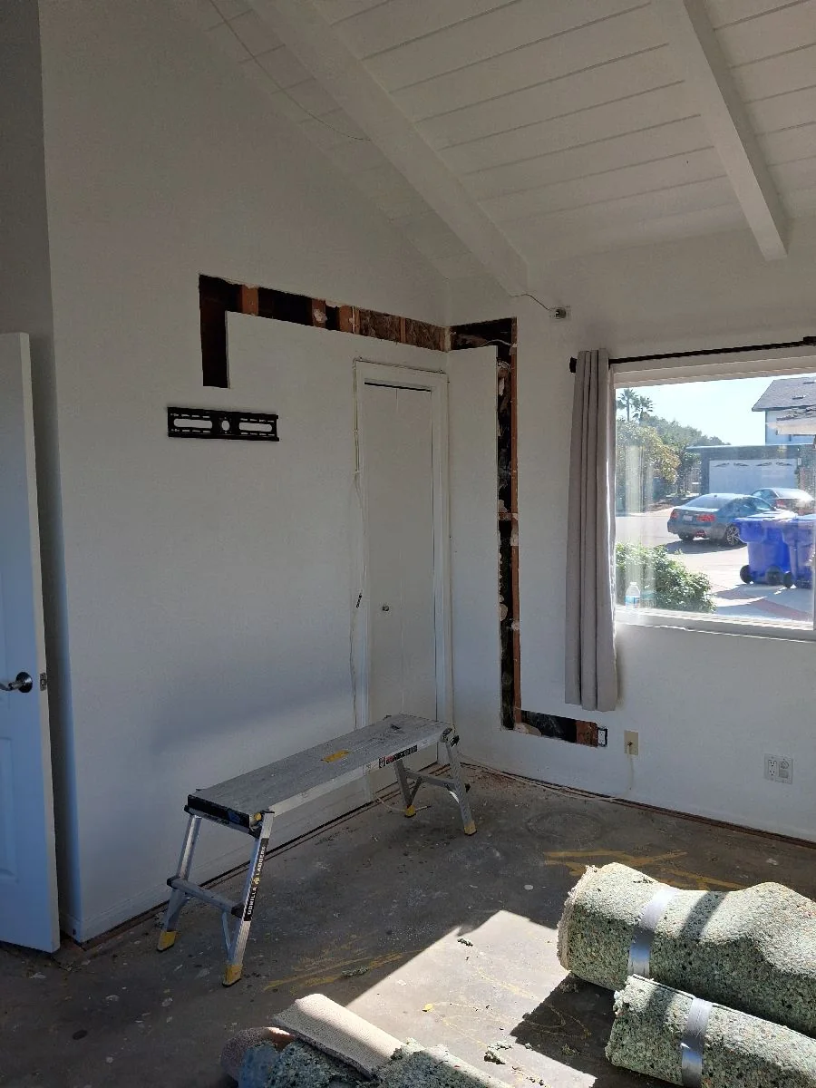 Interior renovation work area with wall framing and a work platform